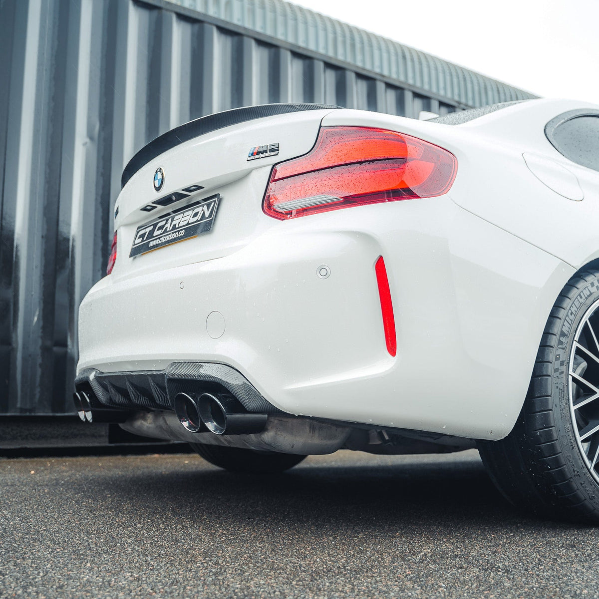 BMW M2 F87 carbon fibre diffuser by CT Carbon, V2 style, showcasing sleek aerodynamic design and high-quality carbon finish.