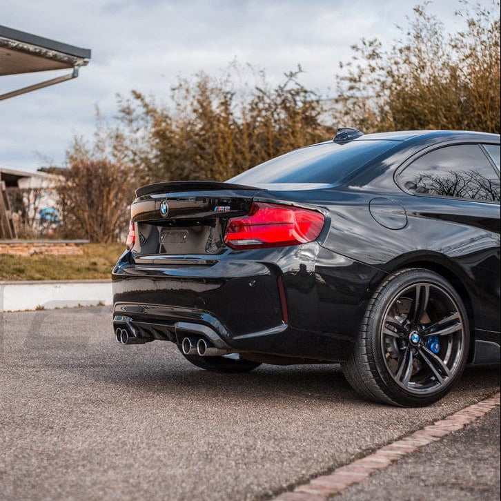 BMW M2 F87 carbon fiber diffuser by CT Carbon, V2 style, showcasing sleek, lightweight aerodynamic design on the car.