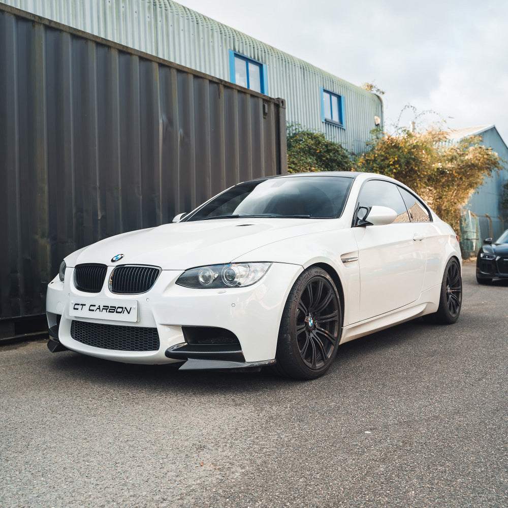 BMW M3 E92/E90 carbon front canard splitters by CT Carbon, showcasing aerodynamic splitters with a sleek black finish.