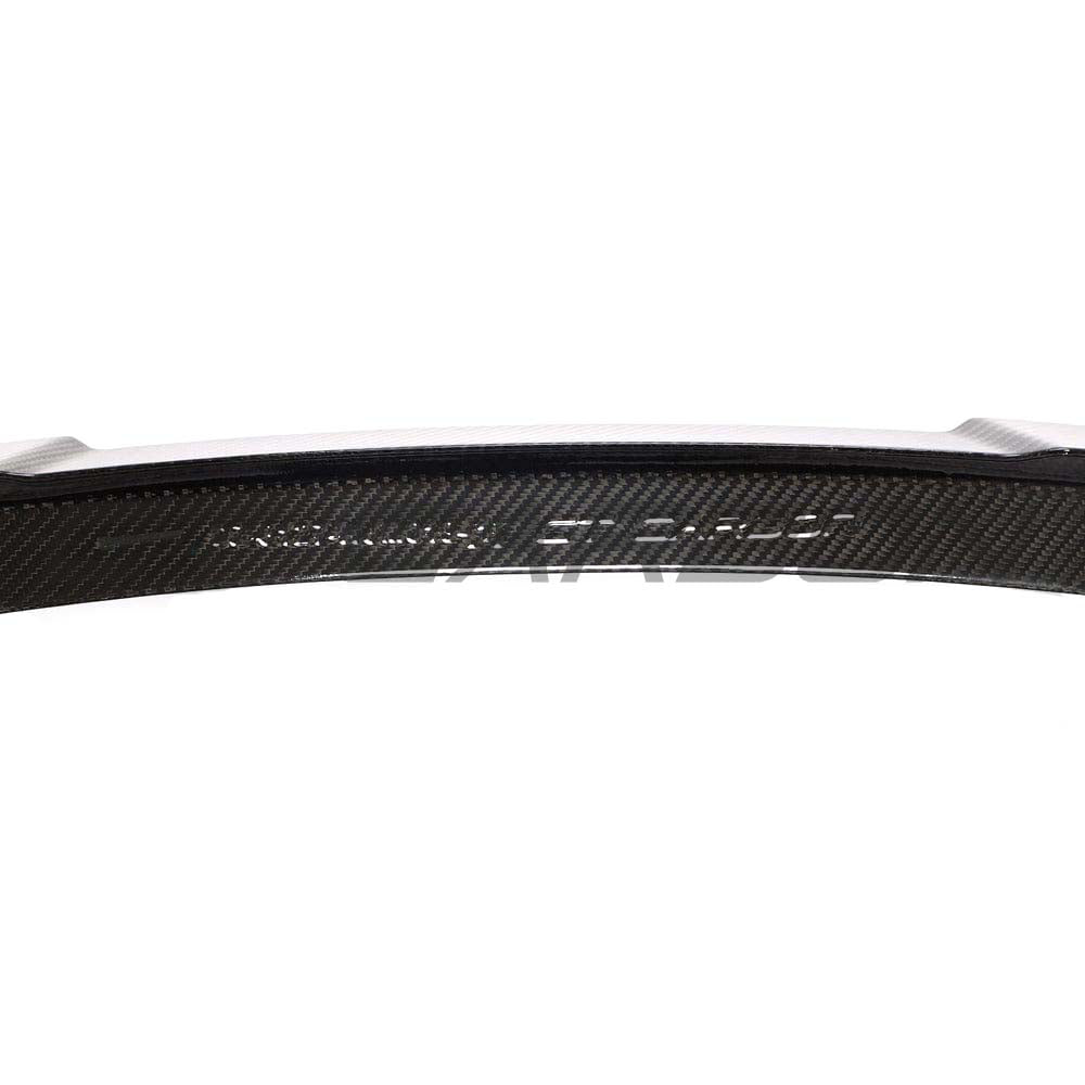 BMW M3 G80 G20 carbon fibre spoiler by CT Design mounted on the car's rear, showcasing a sleek, aerodynamic design.