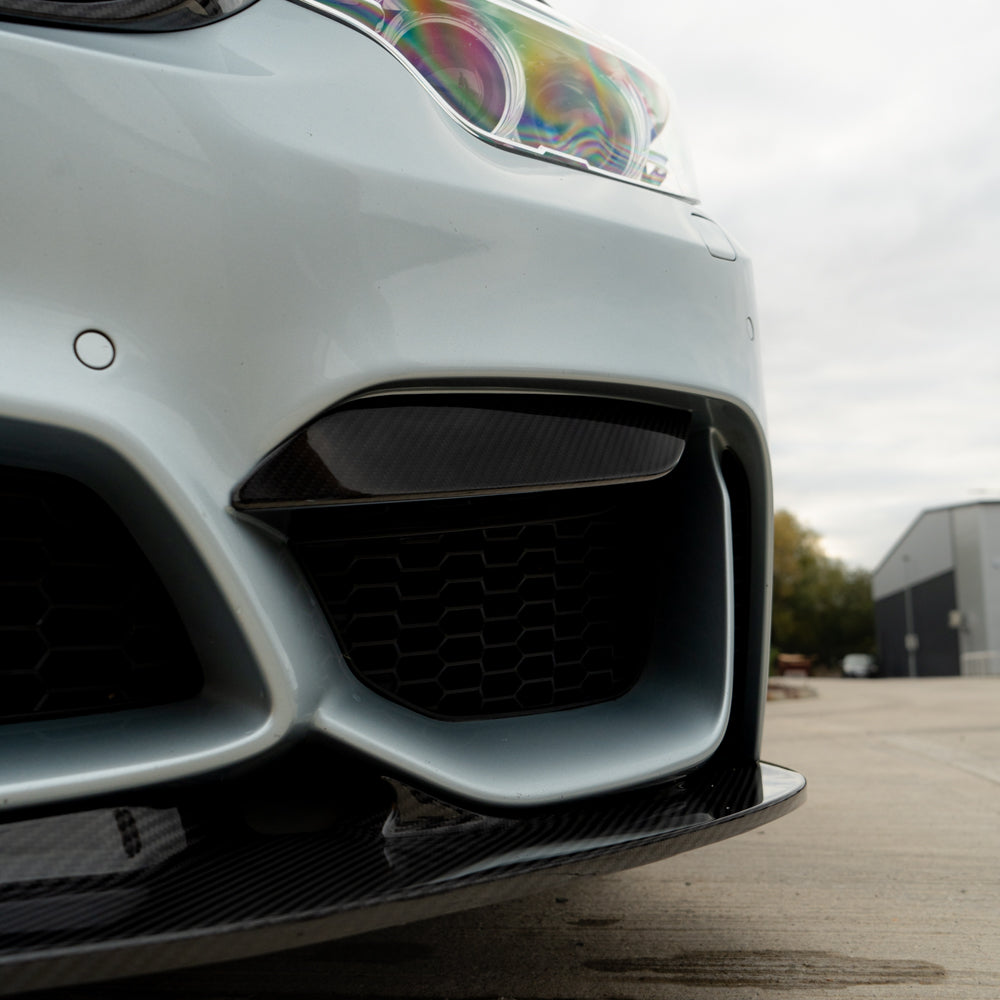 BMW M3 M4 F80 F82 F83 carbon fiber canards, upper front car accessories by CT Carbon, shown mounted on vehicle.