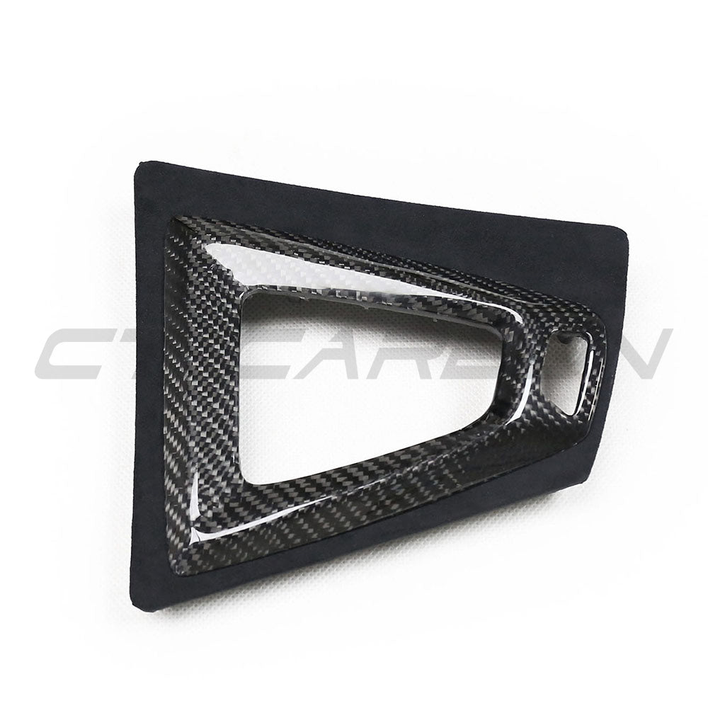 BMW M3 M4 F80 F82 F83 F87 ALCANTARA and carbon shifter surround accessory by CT Carbon, showing close-up of black and carbon detail.