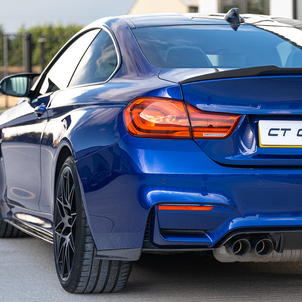 BMW M3 M4 F80 F82 F83 carbon fiber rear bumper corners by CT Carbon, shown in blue on a vehicle.