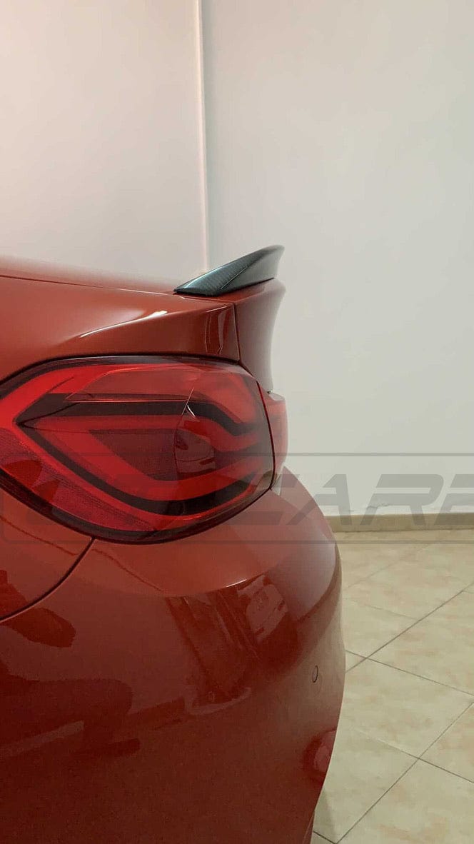 BMW M4 F82 carbon fibre CS style spoiler by CT Carbon, showcasing the sleek, aerodynamic design on the car's rear.