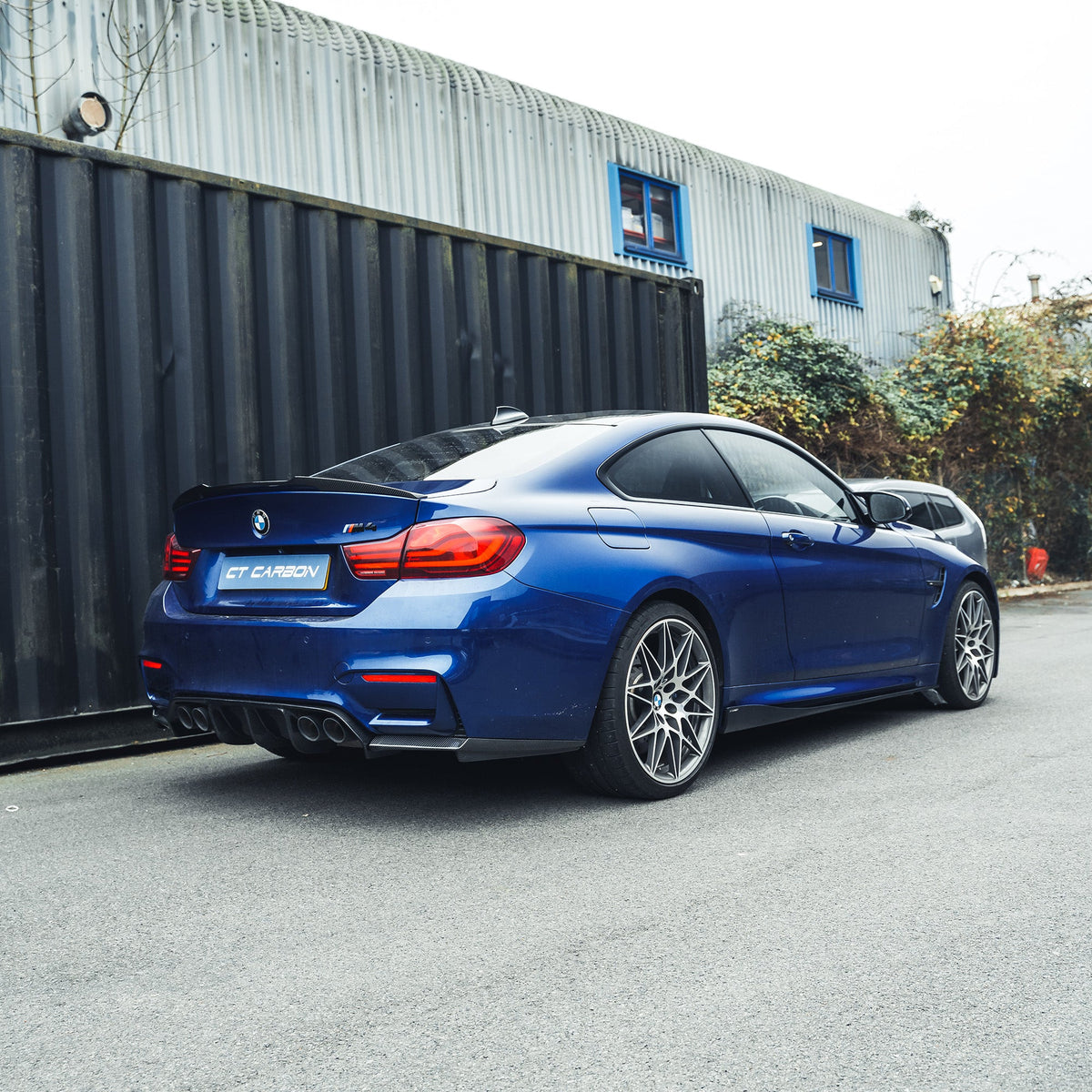 BMW M3 M4 F80 F82 F83 carbon fibre side skirts by CT Carbon installed on the vehicle, showcasing sleek aerodynamic design.