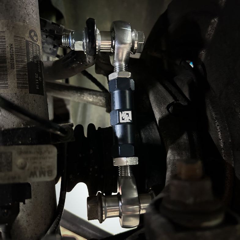 Suspension Secrets adjustable rear drop links for BMW G87 M2, close-up of fitted suspension linkages on the vehicle.