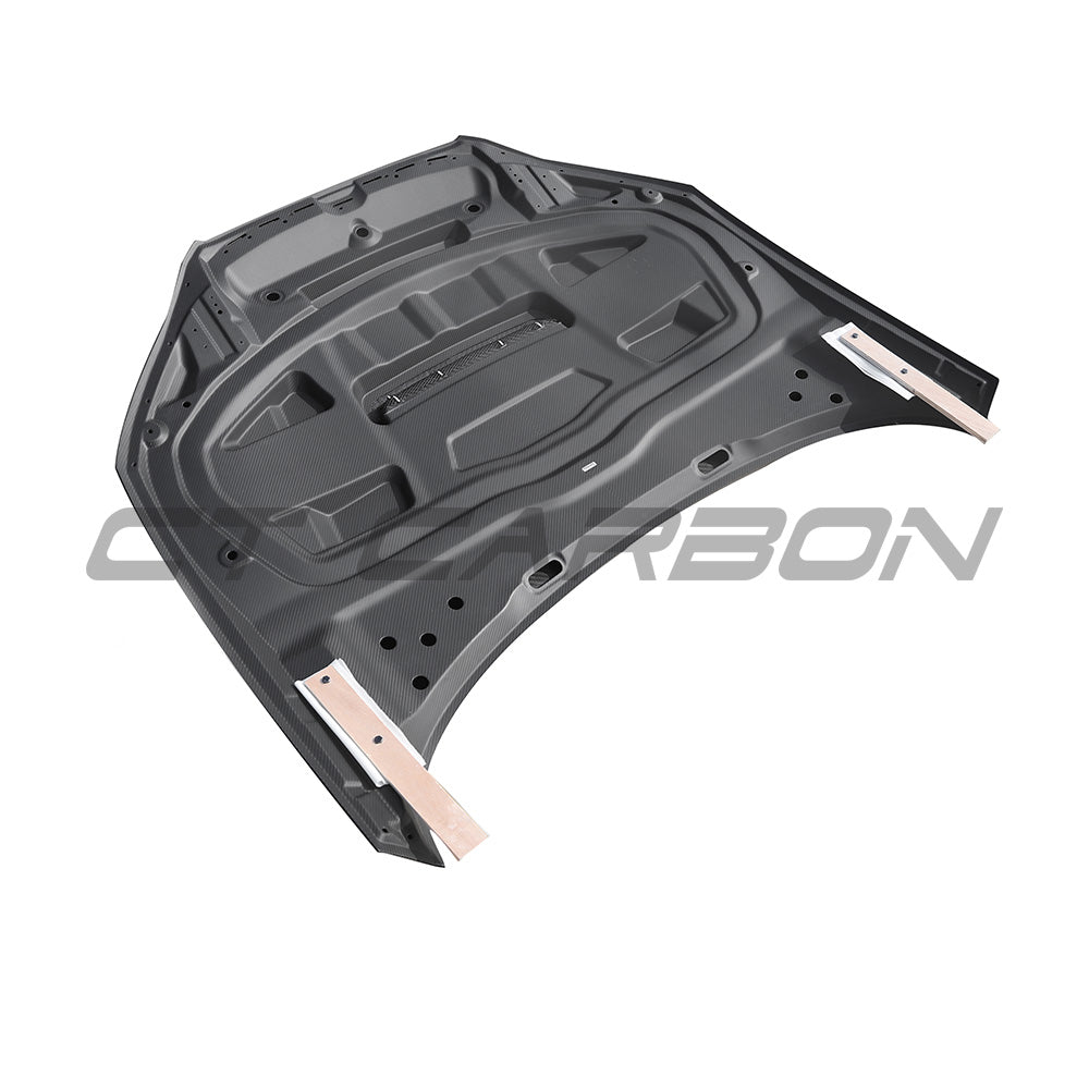 Carbon fiber hood for Audi A6, A7, S6, S7, RS6, RS7 C8 2019-2025 by CT Carbon, showing the textured carbon fiber surface.