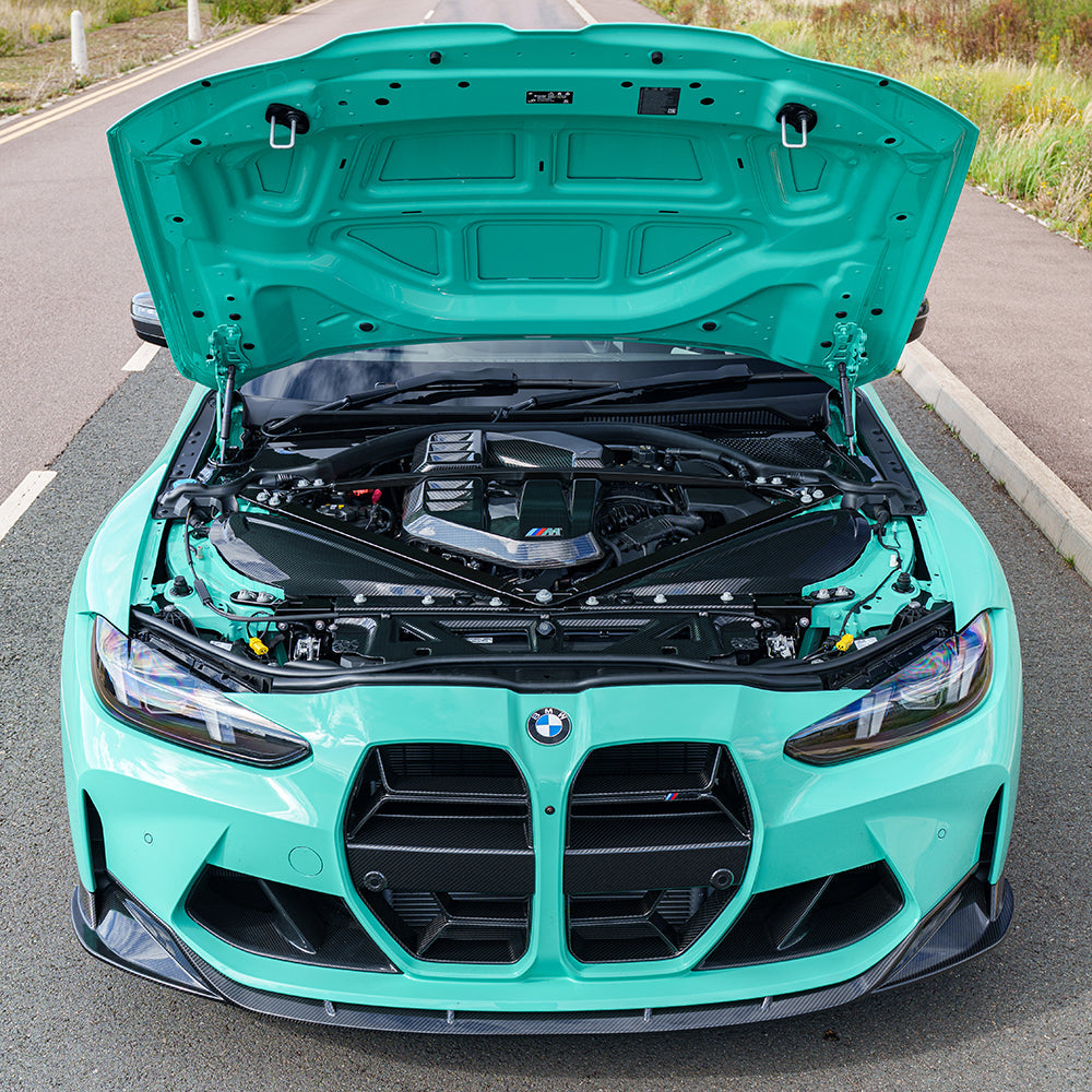 BMW M2 M3 M4 G87 G80 G81 G82 G83 Carbon Fibre Engine Bay Upper Trim by CT Carbon, RHD, close-up of sleek carbon fiber accessory.