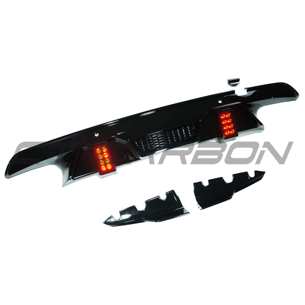 BMW X5M F95 2019+ GLOSS BLACK LED Diffuser V2 by CT Carbon, showing sleek black diffuser with LED accents on a vehicle.