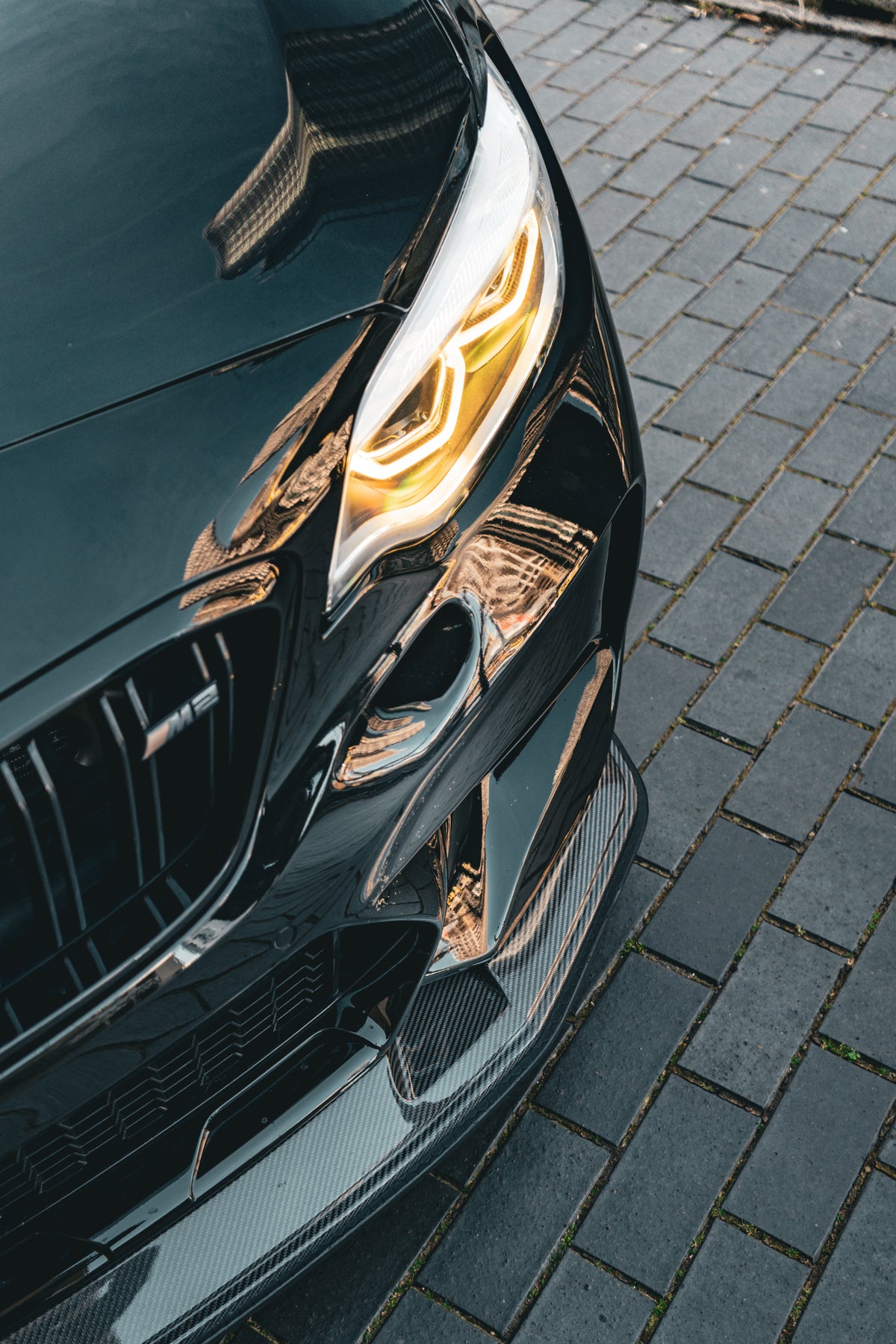 Carbon GTS front splitter for BMW M2 Competition by 72Design, shown attached to the vehicle's front bumper.