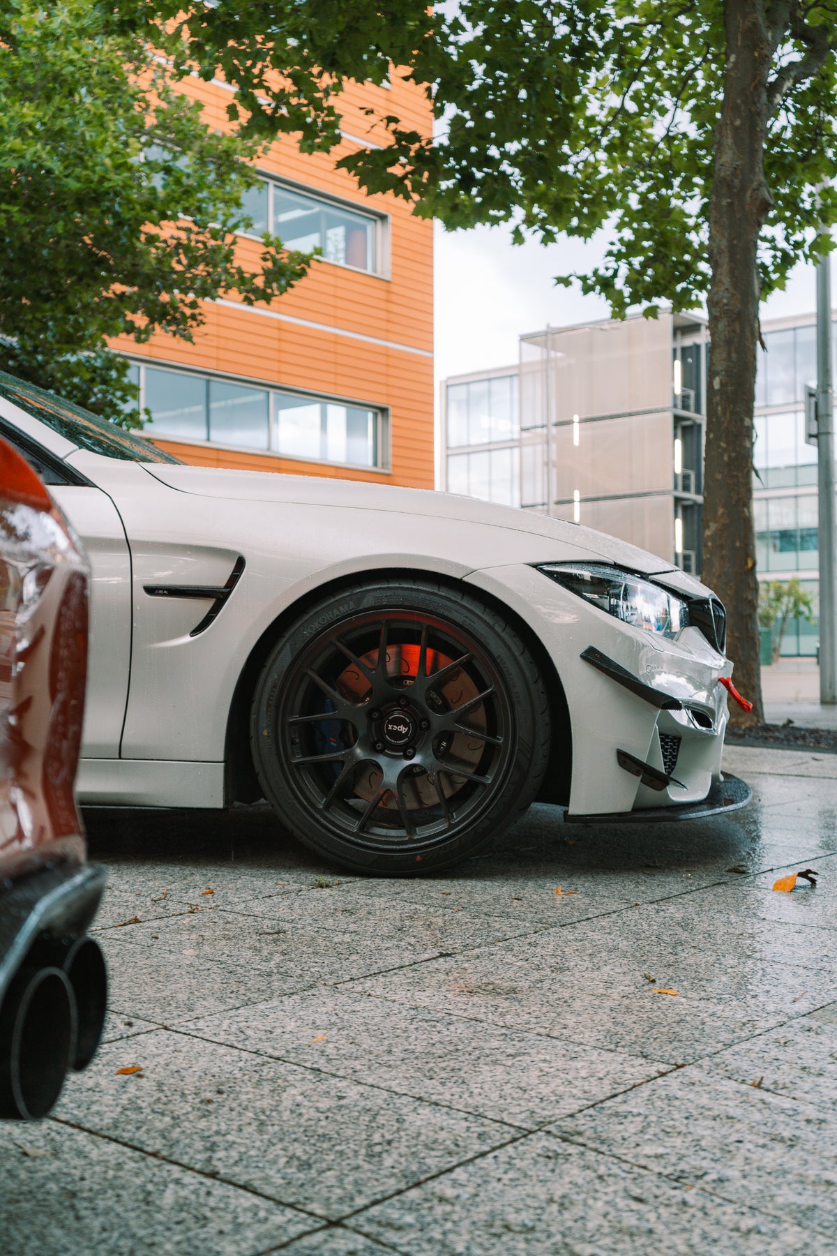 Nineteen72 Performance Carbon GT4 Side Canards for BMW M3 F80 and M4 F82 front bumper trim, showcasing sleek carbon fiber design.