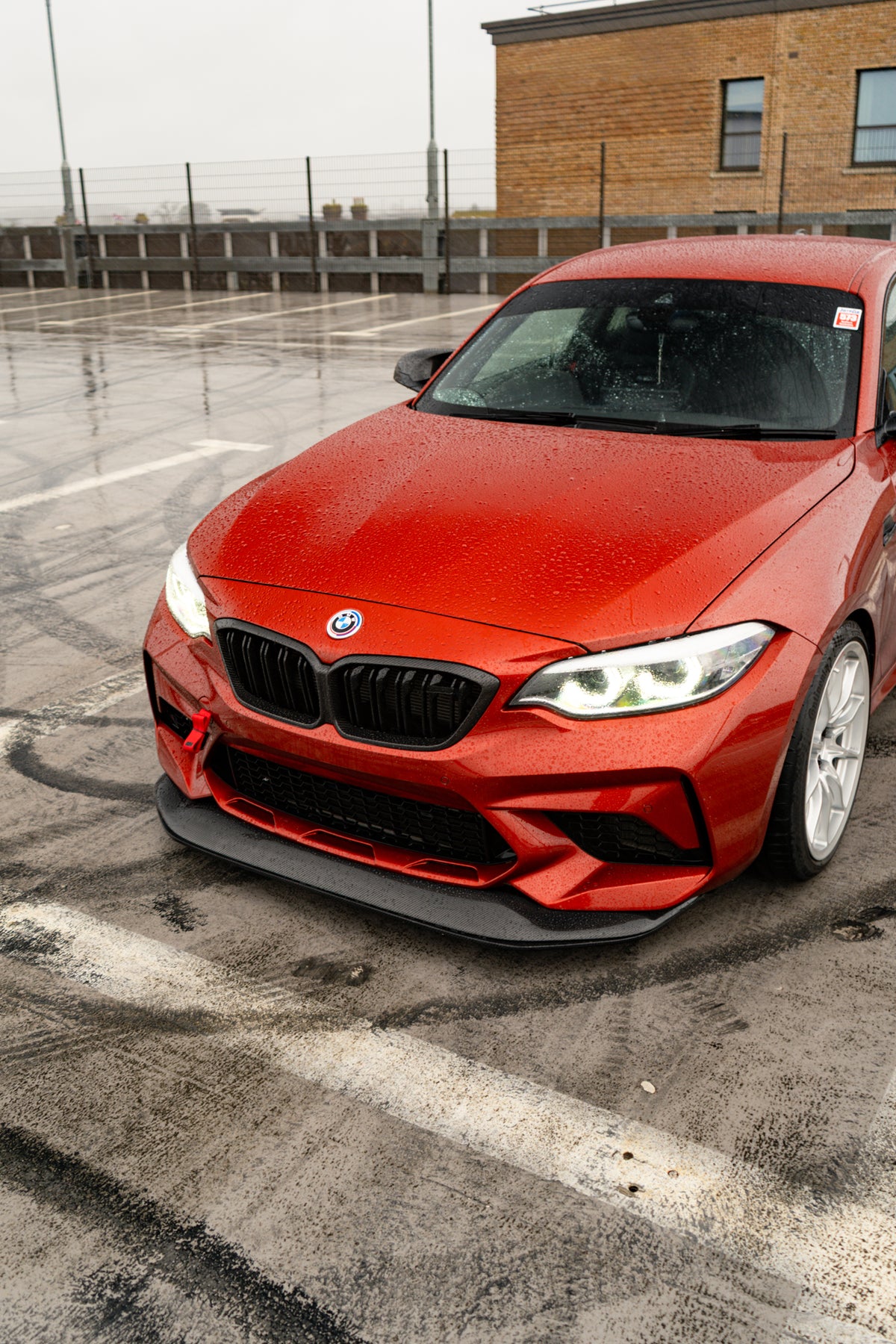 Ridgeline Motorsport F87 M2 Competition carbon fibre GTS front splitter installed on a BMW M2, showcasing aerodynamic design and craftsmanship.