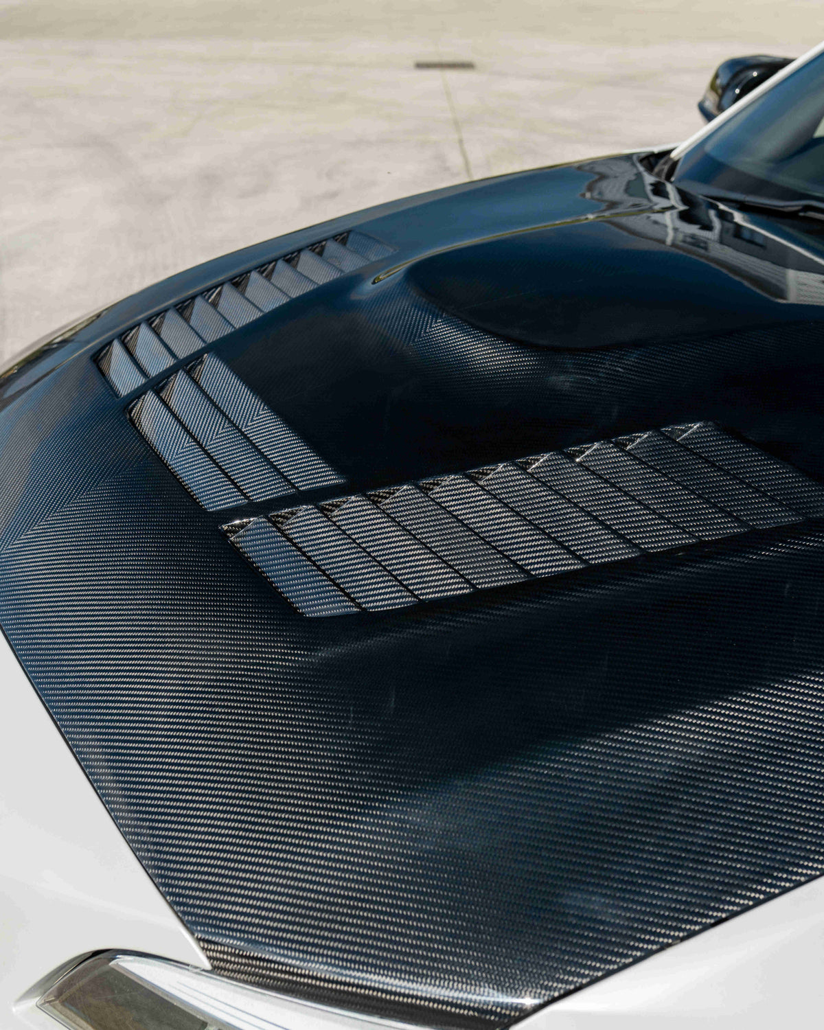 BMW M2 M2C F87 F20 F22 carbon fiber bonnet by CT Carbon, showing sleek, lightweight carbon fiber car hood with detailed weave pattern.