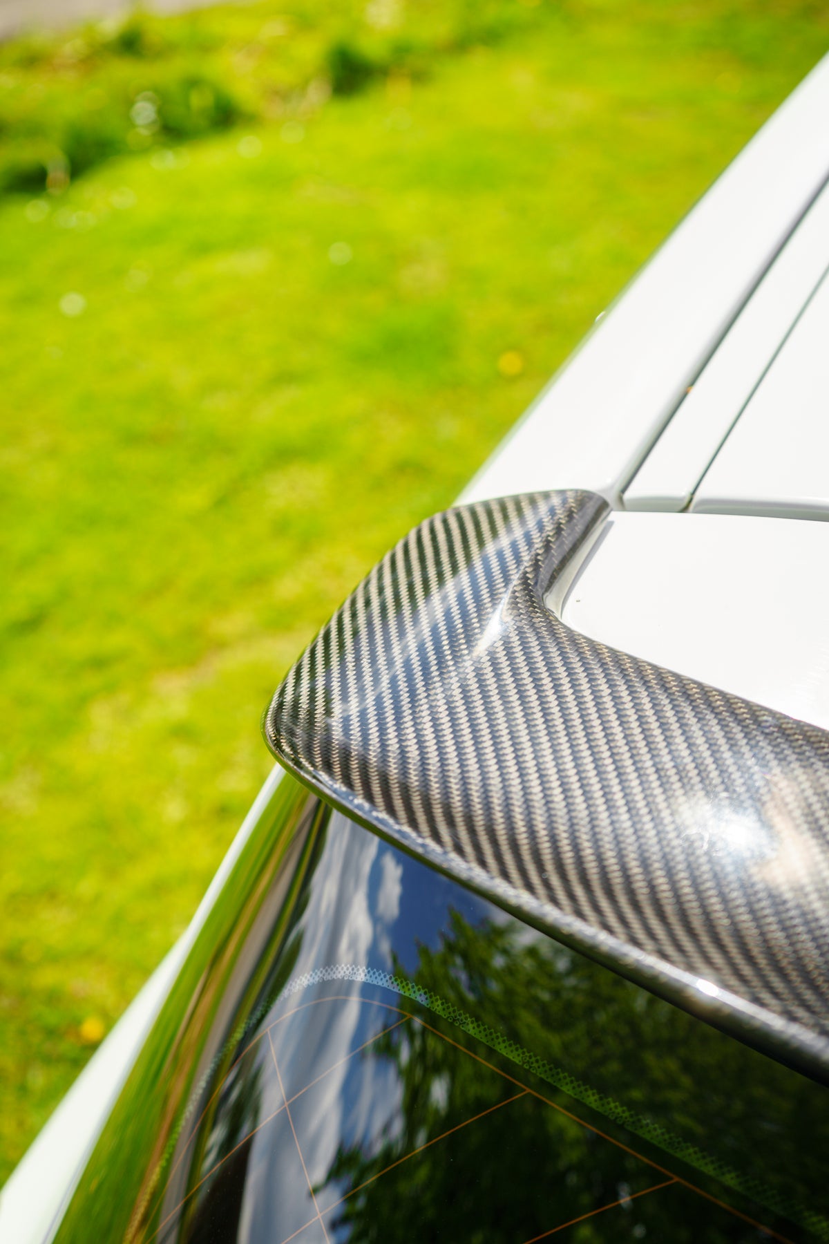 BMW 1 Series F20 gloss carbon fibre performance style spoiler by 72Design, showcasing its sleek, aerodynamic design and high-quality finish.