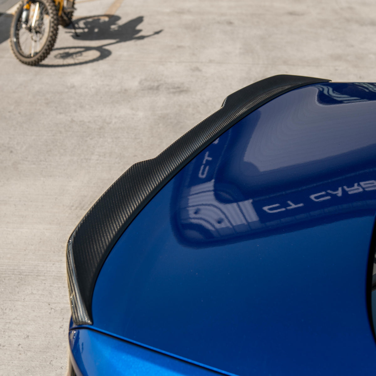 Carbon fiber spoiler for BMW M5 F90 and G30 5 Series, by CT Carbon, shown on a sleek sports sedan.