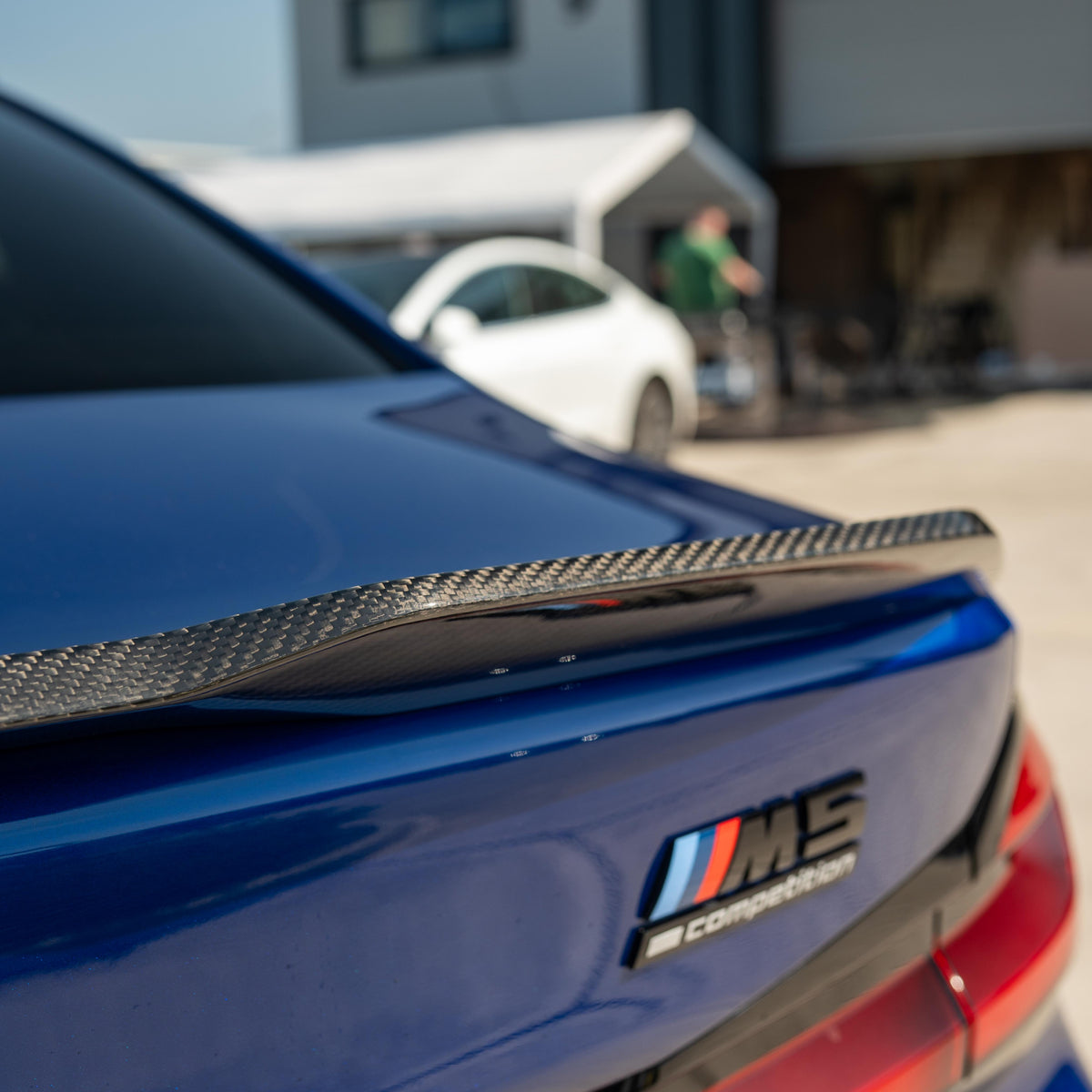 BMW M5 F90 and G30 5 Series carbon fibre spoiler by CT Carbon, showing its sleek, aerodynamic design on the car.