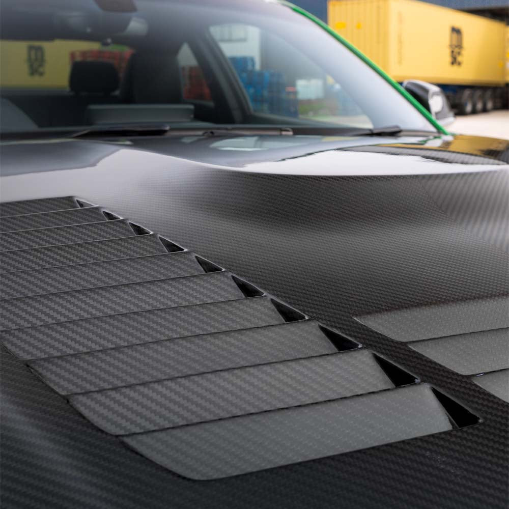 BMW F87 M2 carbon fiber kit by CT Carbon, including full exterior components, showcased on a car with detailed close-up.