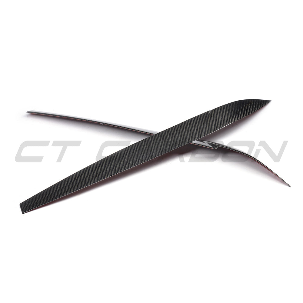 BMW F15/F16 X5/X6 2014-2018 Carbon Fibre Headlight Eyebrows by CT Carbon, close-up of sleek, textured headlight accessory.