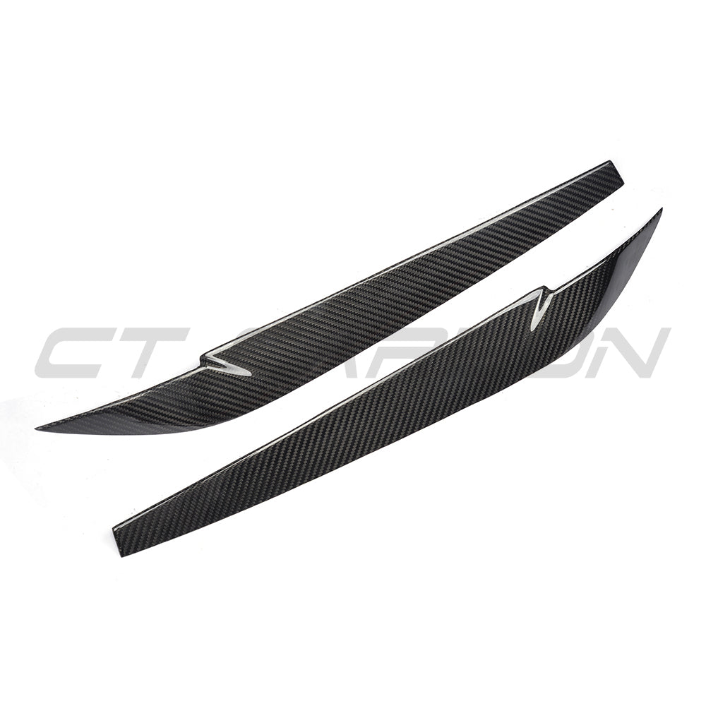 BMW F15/F16 X5/X6 2014-2018 carbon fiber headlight eyebrows by CT Carbon, showing sleek, glossy black accessory on vehicle headlights.