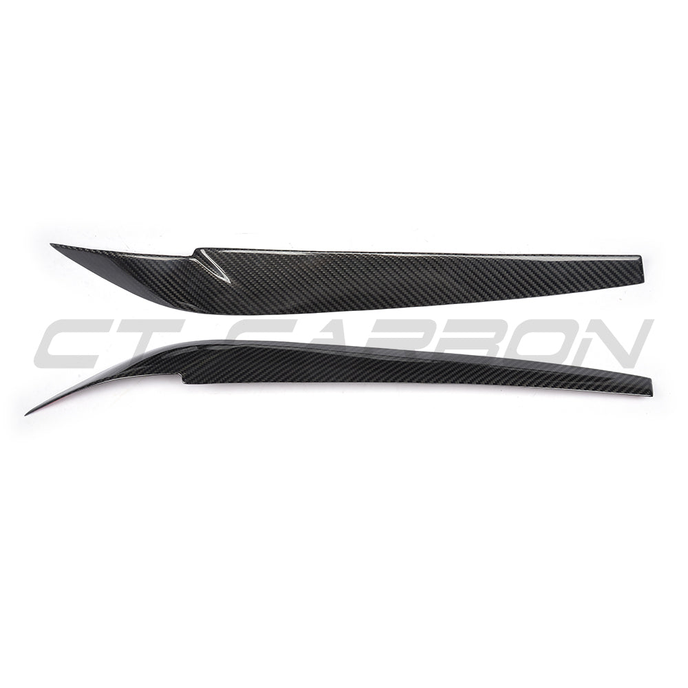 BMW F15/F16 X5/X6 carbon fiber headlight eyebrows accessory by CT Carbon, showing sleek, textured carbon fiber details on headlights.