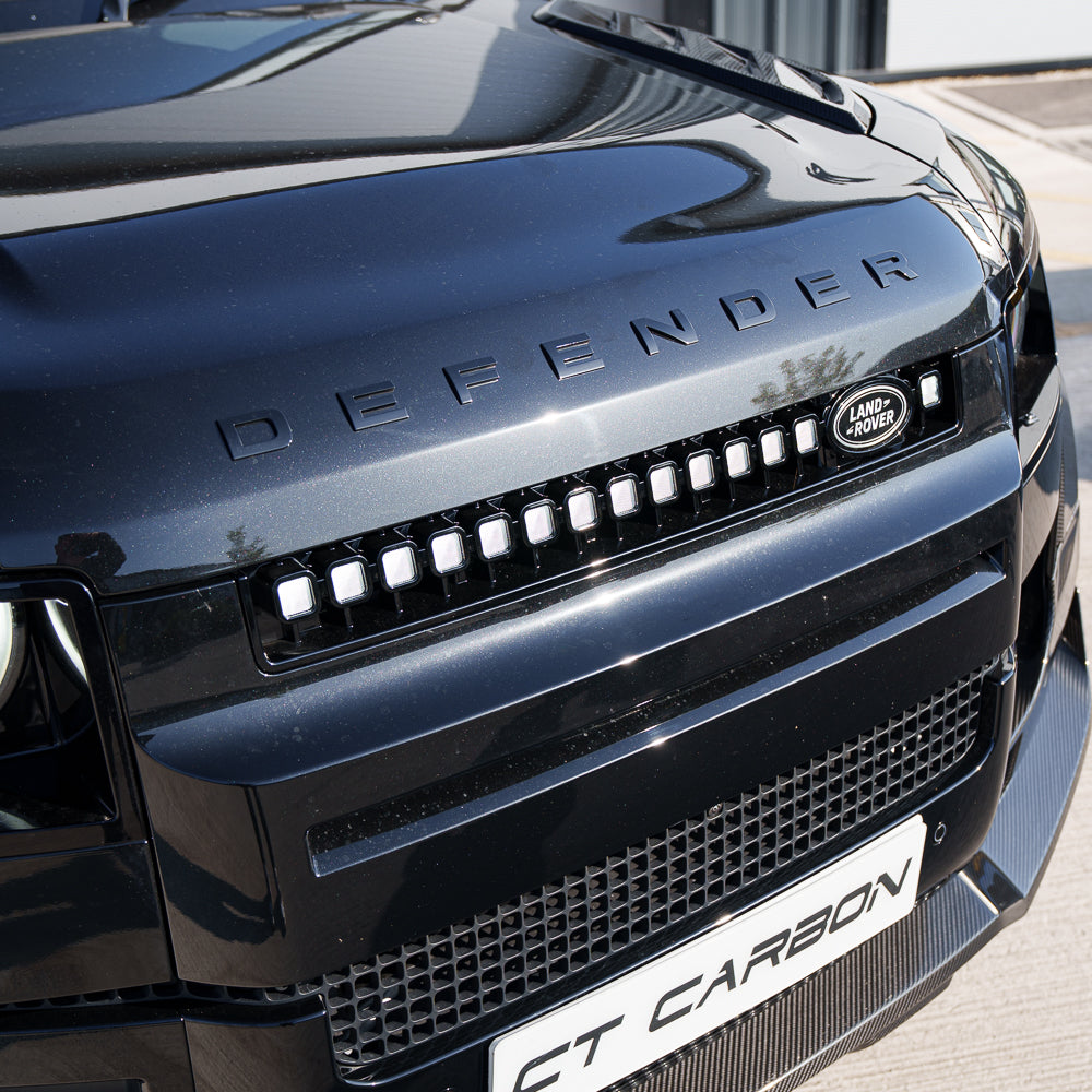 Yellow LED grille for Land Rover Defender L663 2019+ by CT Carbon, showcasing the V3 design on a rugged vehicle.