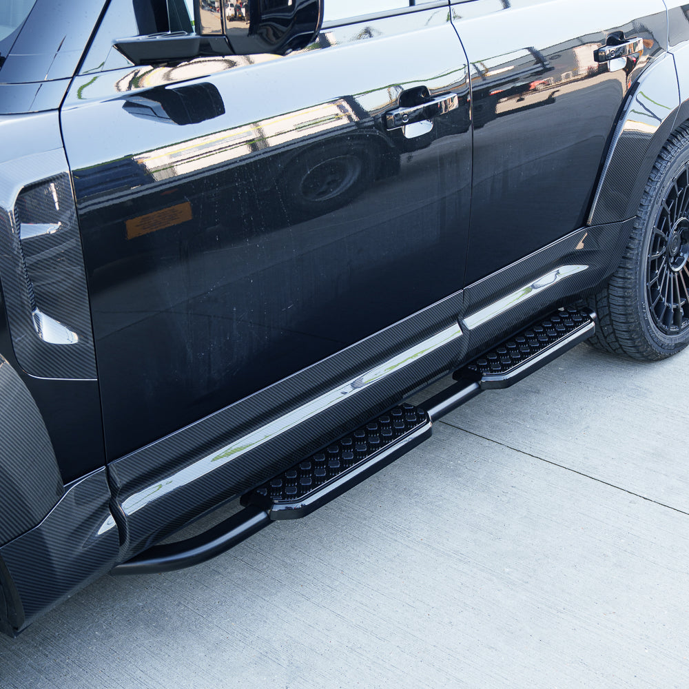 Land Rover Defender 110 L663 side steps by CT Carbon, durable accessories with textured surface for easy vehicle entry.