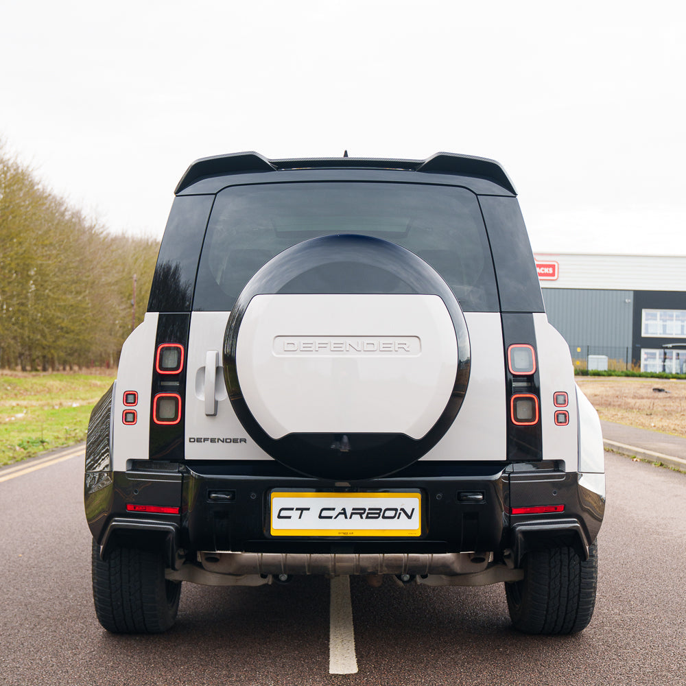 Carbon fiber spoiler for Land Rover Defender L663 by CT Carbon, mounted on the vehicle's rear for aerodynamic enhancement.