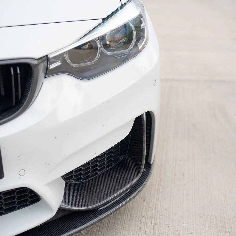 BMW M3 M4 F80 F82 F83 carbon fiber splitter kit, three-piece set by CT Carbon, shown installed on the front of the vehicle.