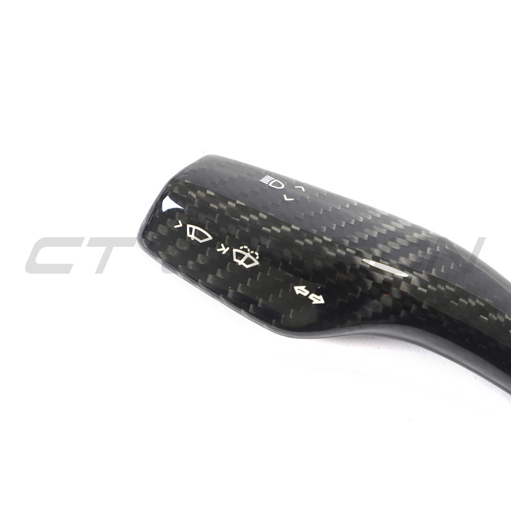 Tesla Model 3 and Y 2017+ carbon fiber stalk cover by CT Carbon, close-up of black textured automotive accessory.