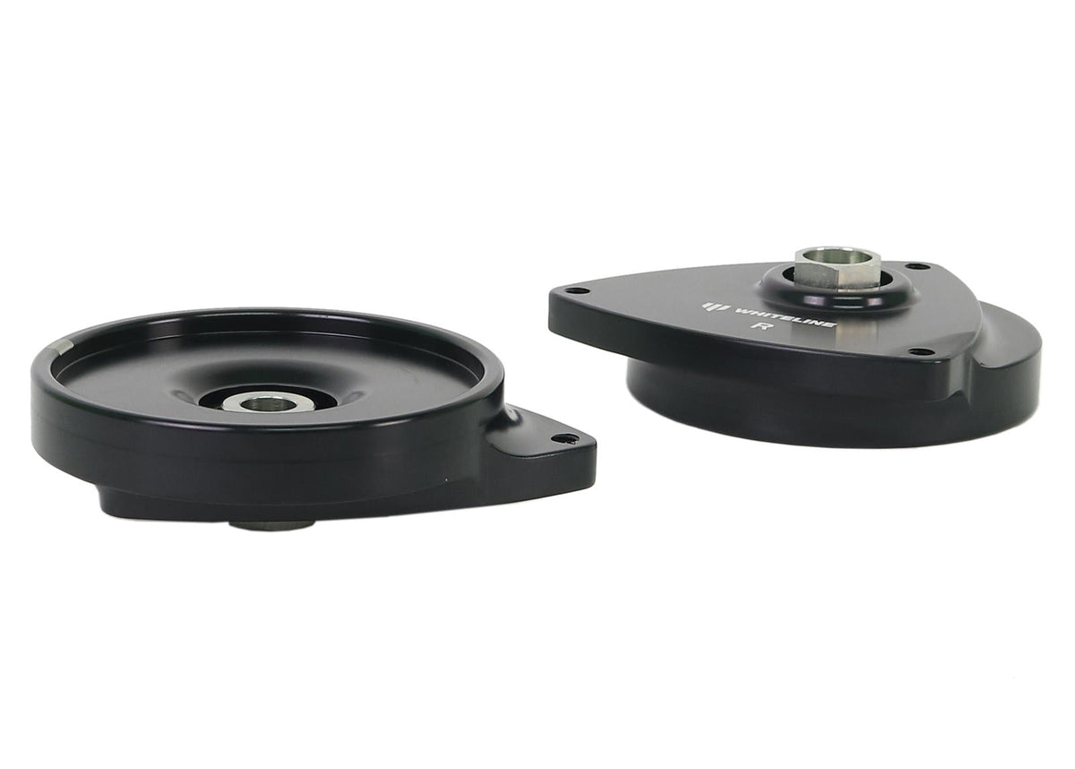 Whiteline front strut mount kit with bushings, showing the rubber components and metal mounting parts.