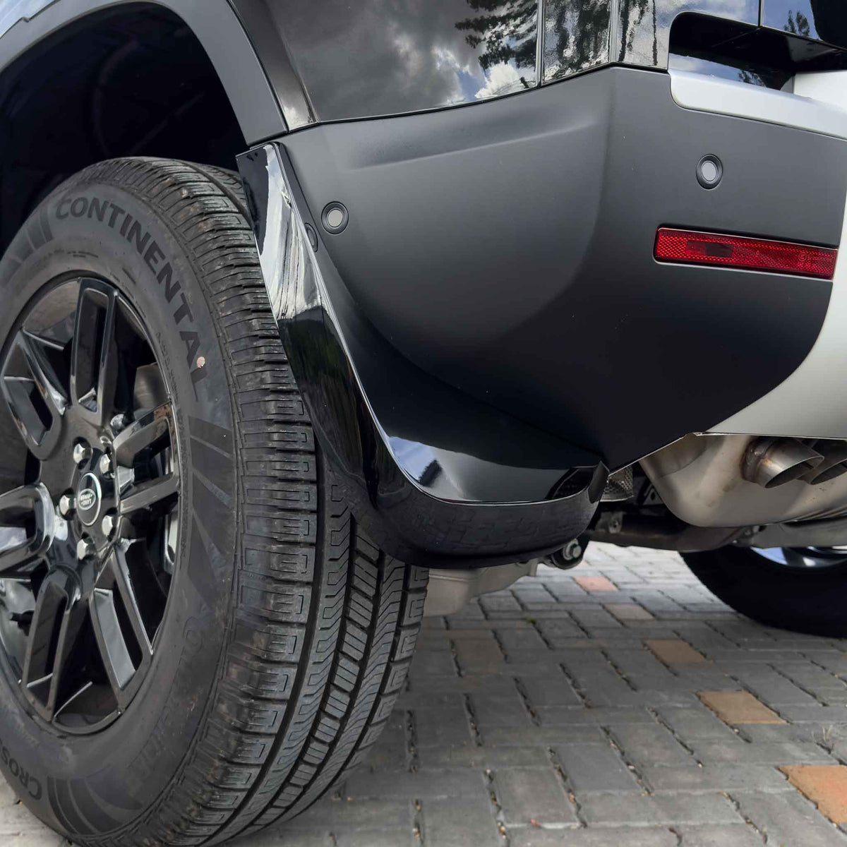 Gloss black mud flaps for Land Rover Defender L663 110 and 90 models by CT Carbon, durable automotive accessories.