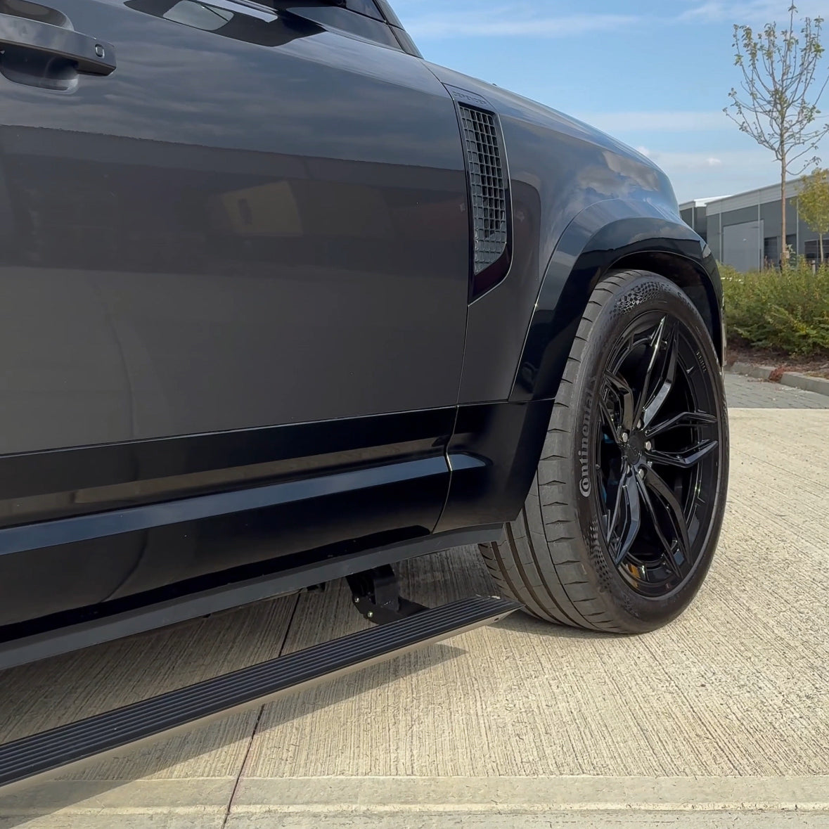Electric fold-out side steps for Land Rover Defender L663 110 by CT Carbon, shown extended alongside the vehicle.
