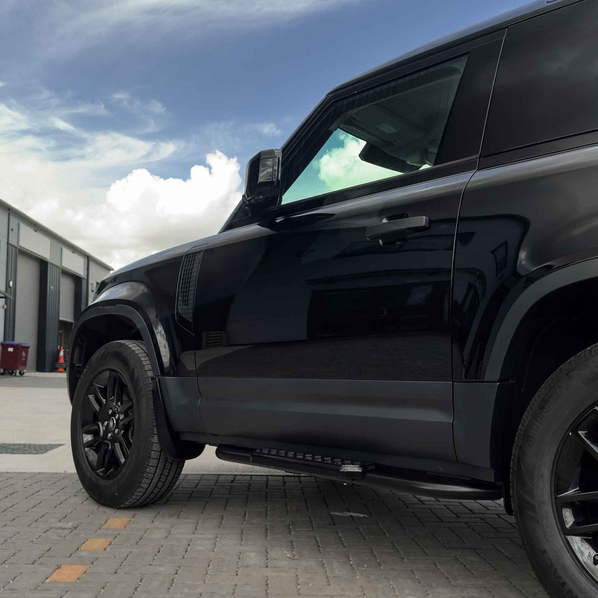 CT Carbon side steps for Land Rover Defender L663 90, mounted on the vehicle's side for easy access and enhanced appearance.