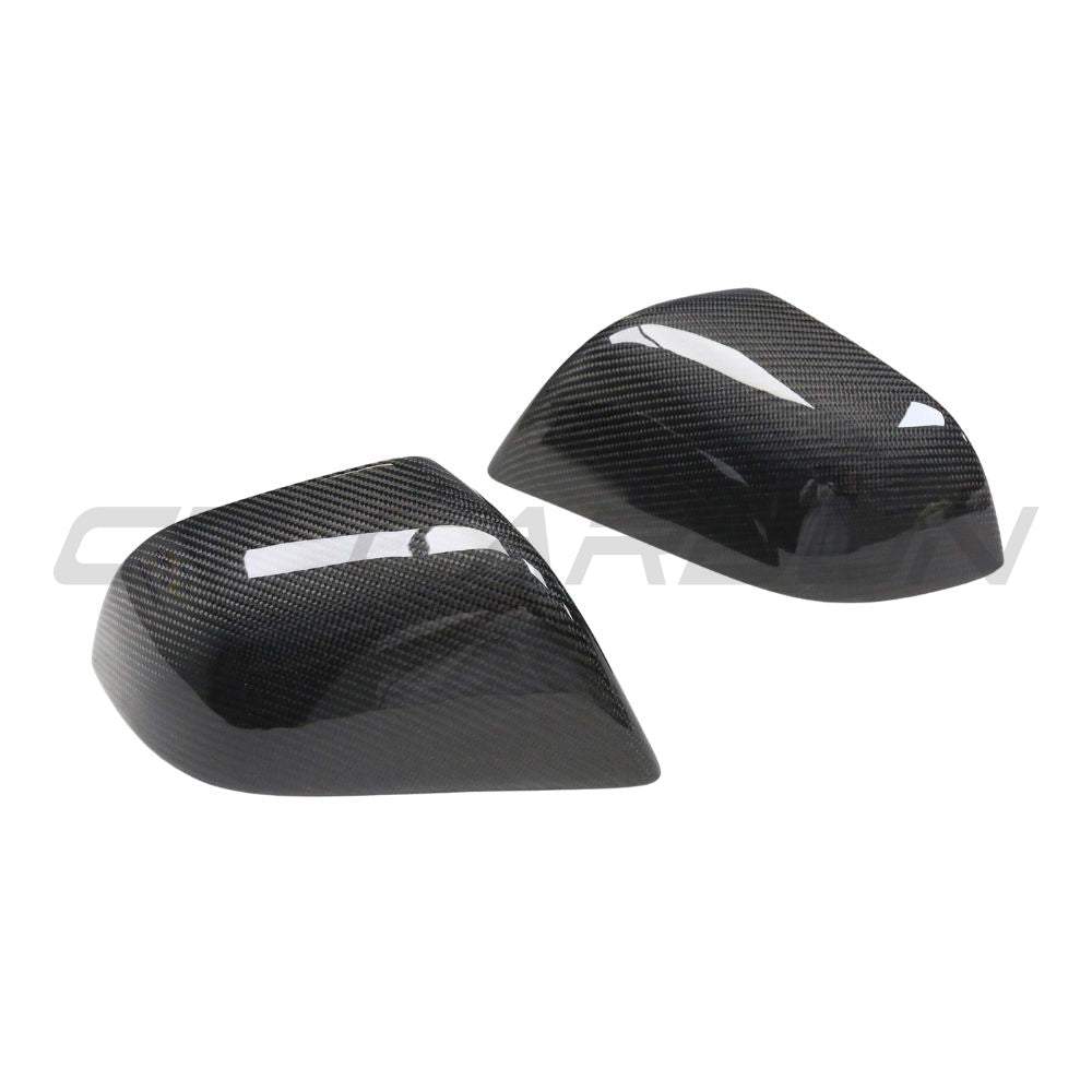 Carbon fibre side mirror covers for Tesla Model 3 2017-2023, by CT Carbon, showcasing sleek, textured automotive accessories.