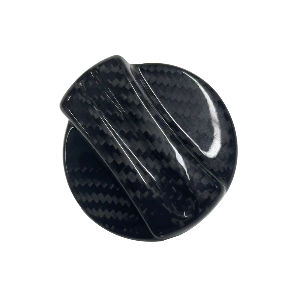 BMW 2010+ carbon fiber fuel cap cover by CT Carbon, close-up view showing sleek black finish and textured carbon fiber pattern.