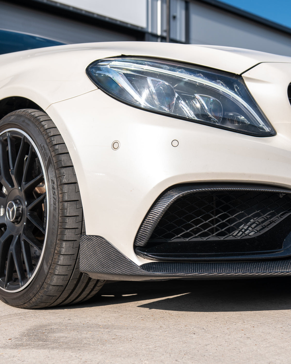 Mercedes C63 W205 sedan estate CT Carbon V1 carbon fibre splitter installed on front bumper showing sleek, aerodynamic design.