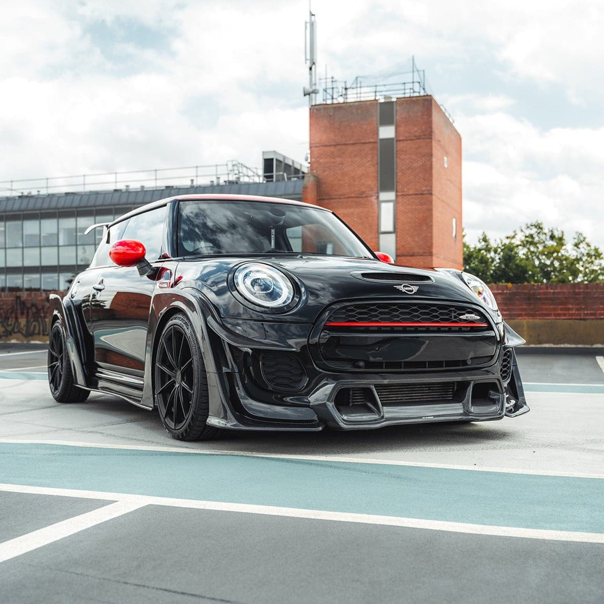 Carbon fibre wide arch kit for MINI Cooper S F56 JCW Sport Pack by CT Carbon, featuring sleek, wide-arch design and racing-inspired details.