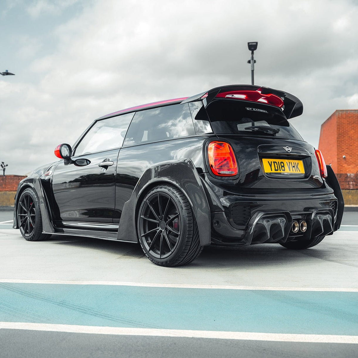 Close-up of the CT Carbon Mini Cooper S F56 JCW Sport Pack carbon fiber wide arch kit on a compact hatchback.
