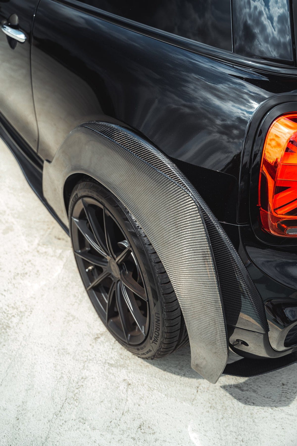 Carbon fiber wide arch kit for MINI Cooper S F56 JCW Sport Pack by CT Carbon, featuring sleek, custom-fitted wheel arch extensions.
