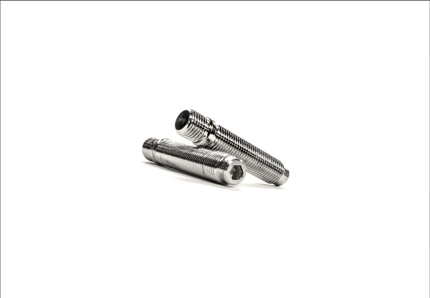 MMX Performance BMW Mini wheel stud and nut conversion kit with metal studs and nuts for secure wheel attachment.
