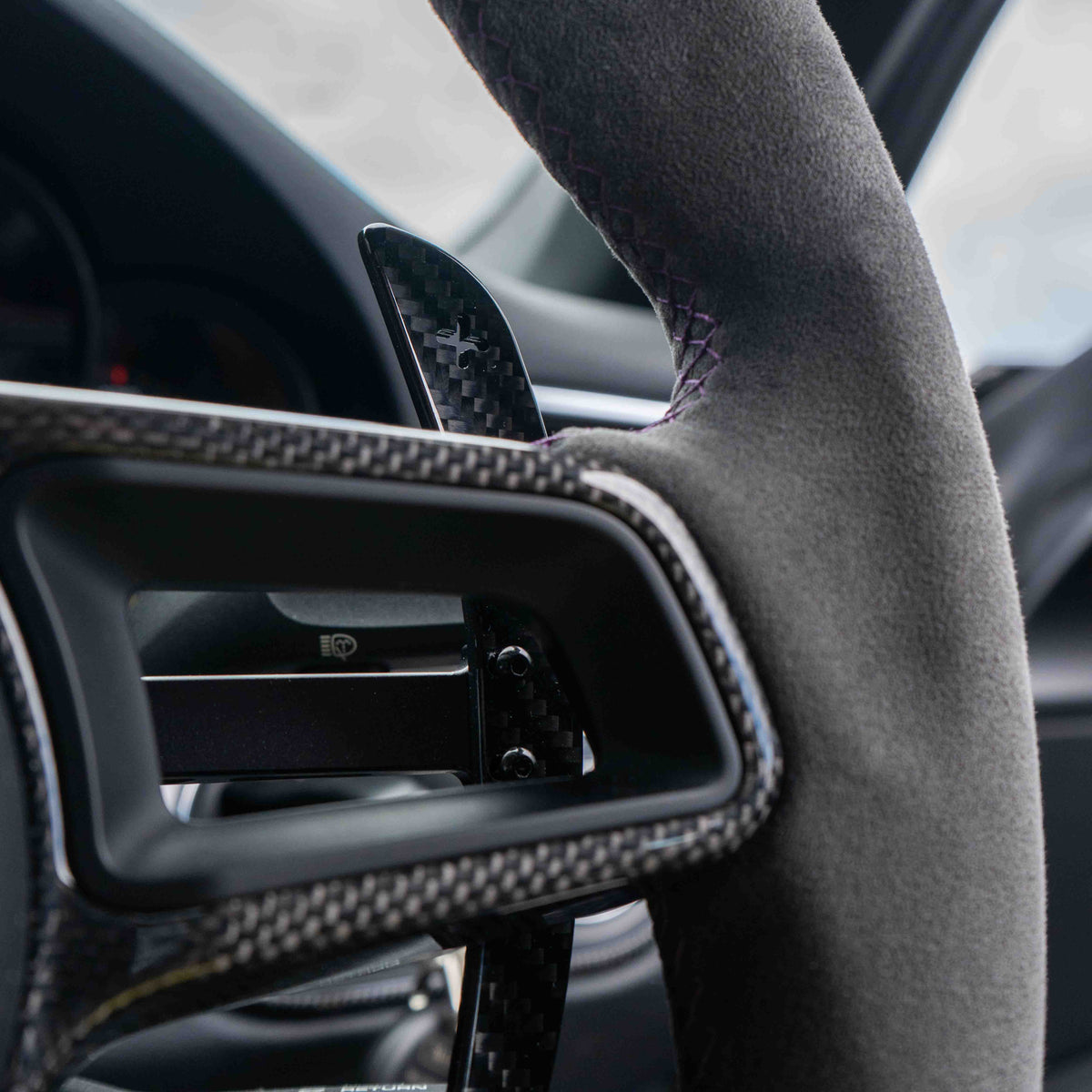 Carbon fiber paddle shifters for Porsche 911, Cayman, Boxster, Cayenne, and Macan 2013+ by CT Carbon, shown in close-up.