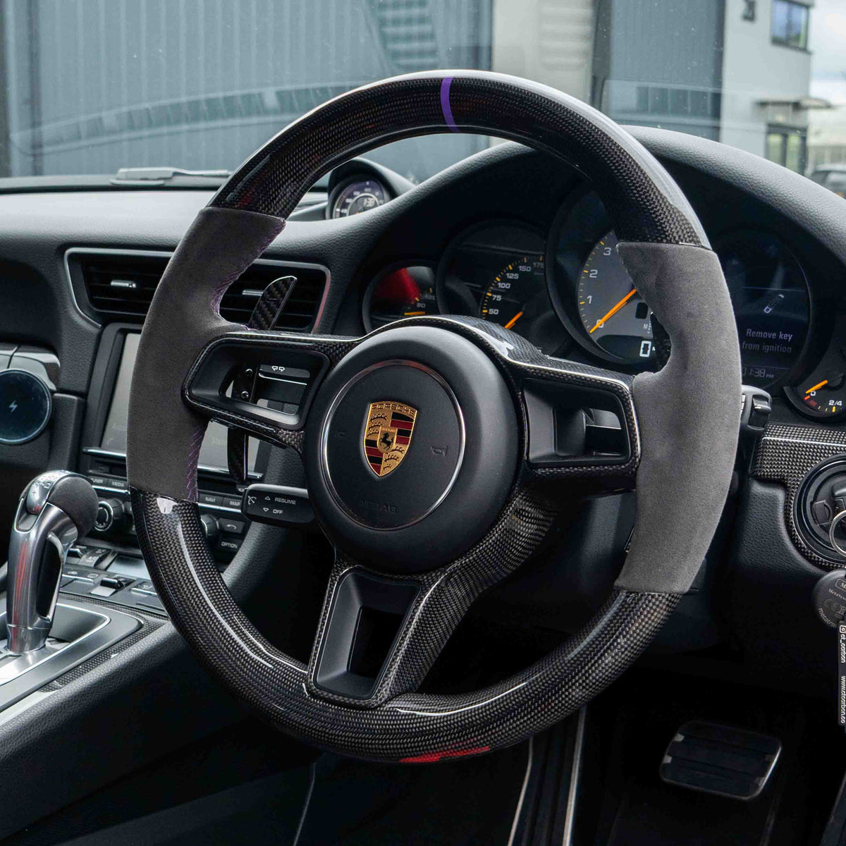 Porsche 911, Cayman, Boxster, Cayenne, Macan magnetic carbon fiber paddle shifters by CT Carbon installed in the car interior.