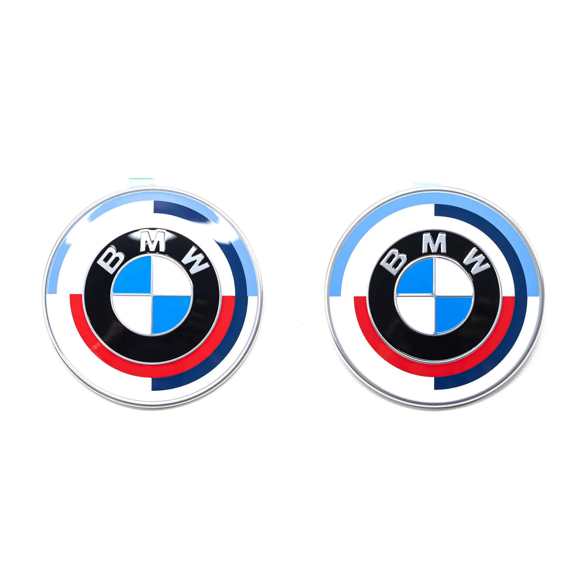 Genuine BMW 50 Years of M front and rear badge emblems for F87 M2, showcasing authentic M performance branding on hood and trunk.