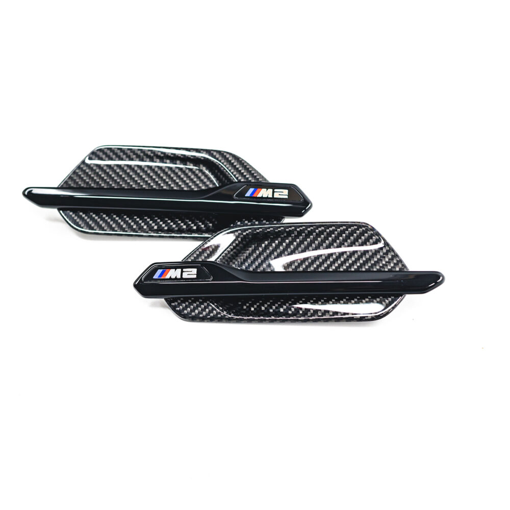 Genuine BMW F87 M2 M Performance carbon fiber side grille air breathers on exterior trim, showcasing sleek design and craftsmanship.