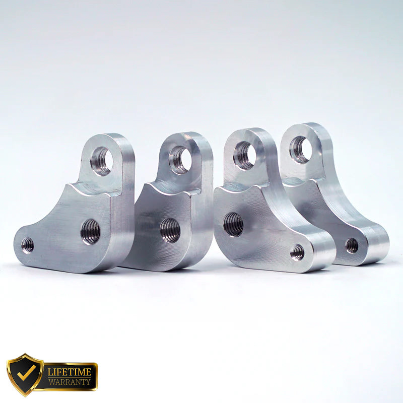 Suspension Secrets seat raisers for Porsche 718 GT4 RS showing metal suspension linkages with mounting points and hardware.