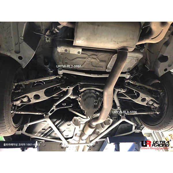 Ultra Racing BMW 2 Series F87 rear lower strut brace installed, showing its black metal construction and mounting points.