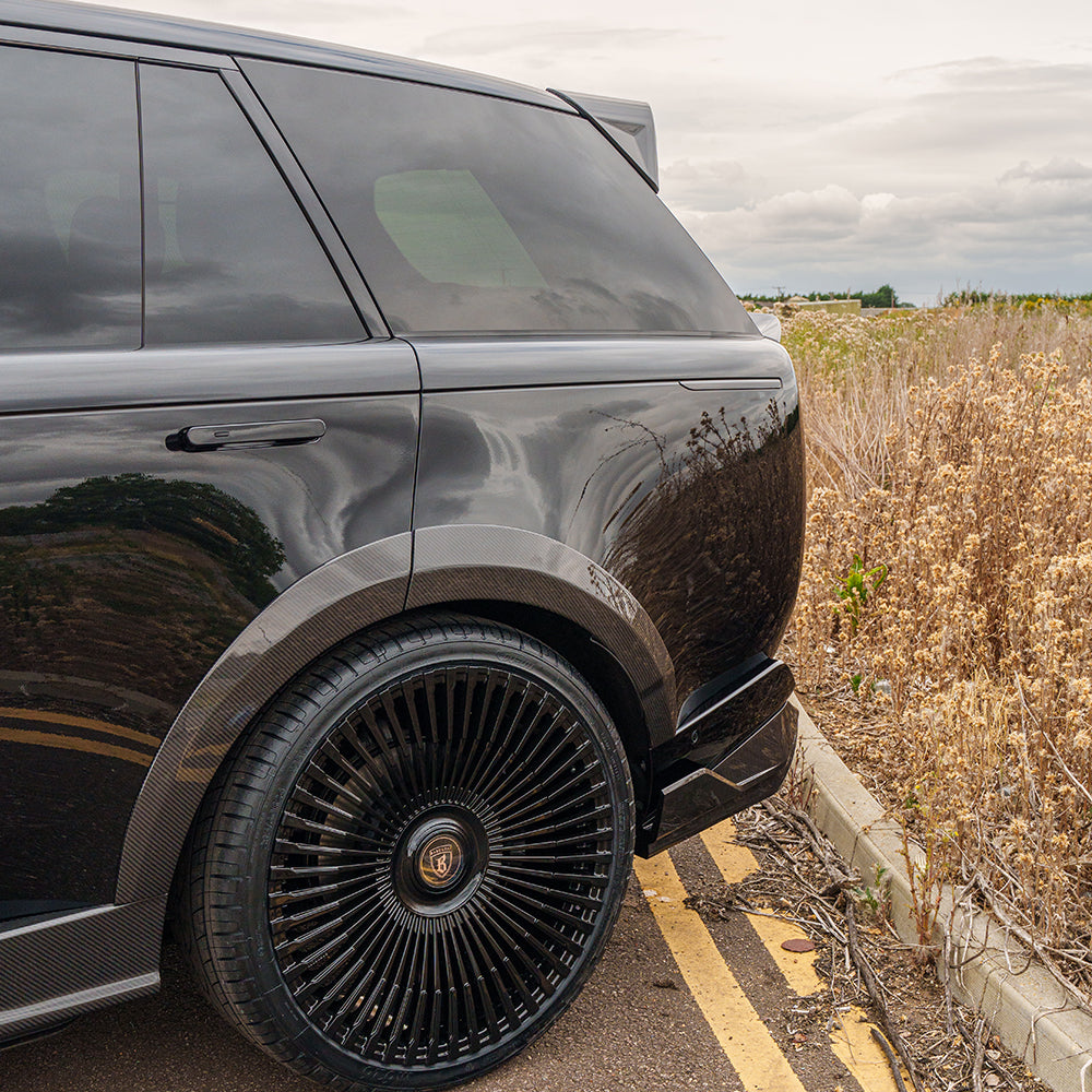 Range Rover L460 2022+ carbon fibre roof spoiler by CT Carbon, showcasing sleek, aerodynamic design on a luxury SUV.