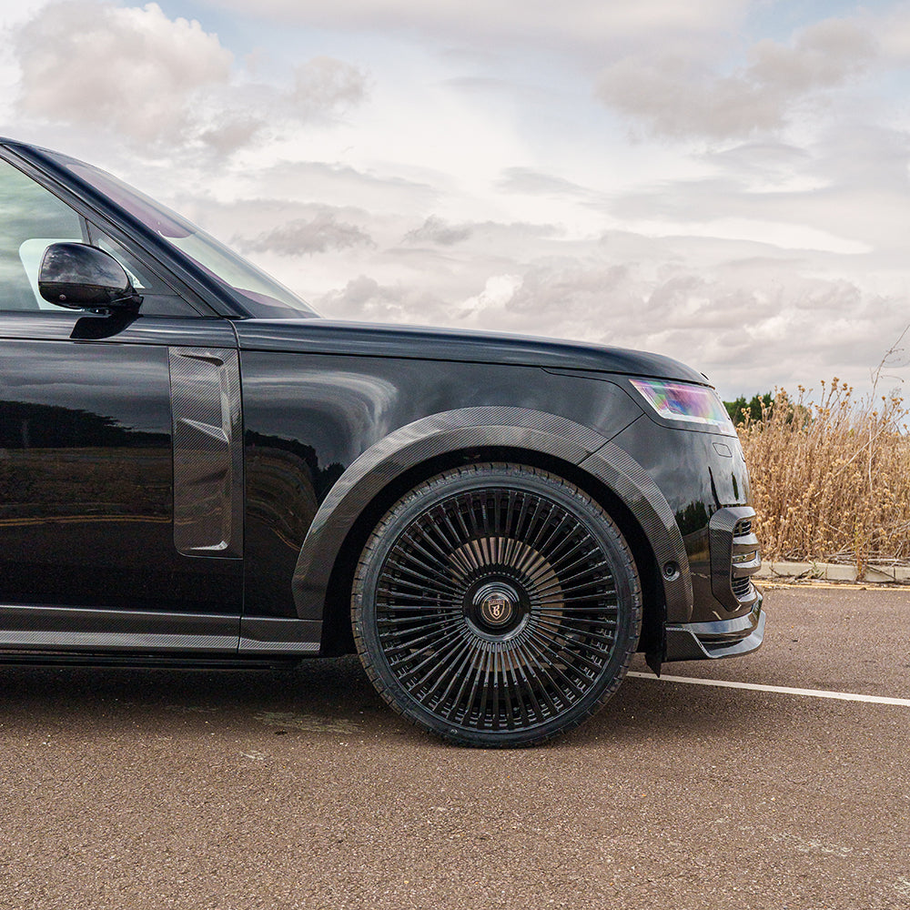 Range Rover L460 2022+ carbon fibre wide arch extensions by CT Carbon, showcasing sleek, aerodynamic design on vehicle arches.