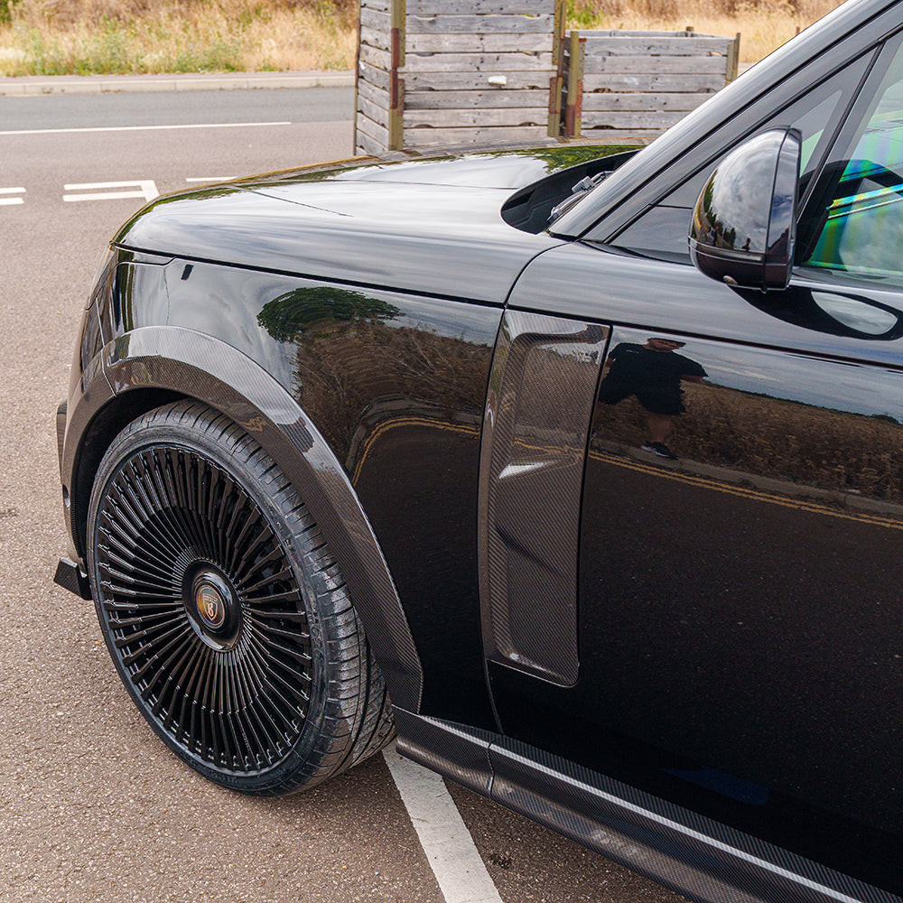 Range Rover L460 2022+ carbon fibre wide arch extensions by CT Carbon, showing sleek, textured aerodynamic wheel arches.