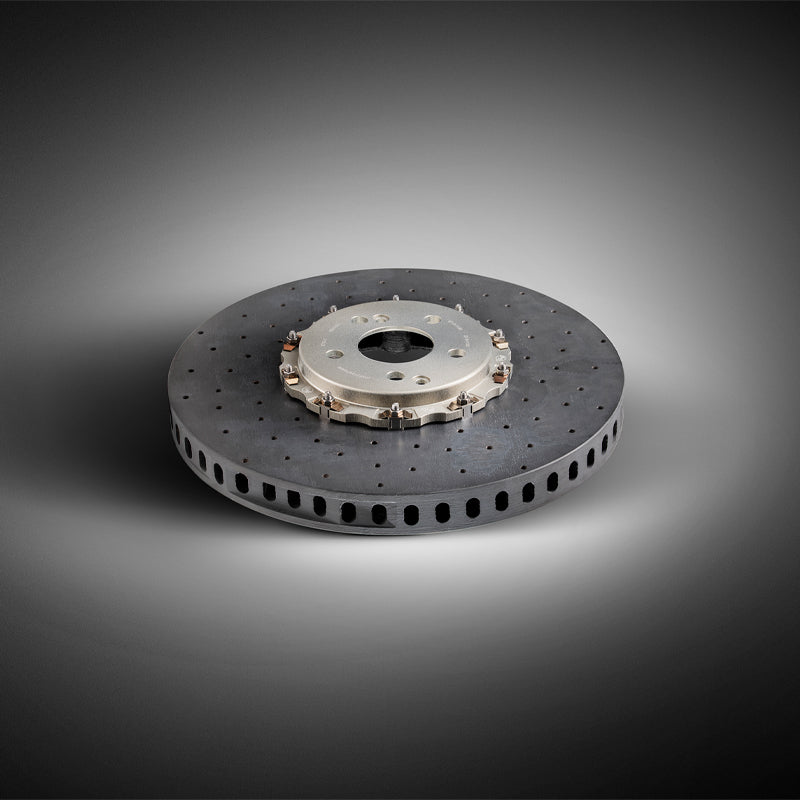 Suspension Secrets surface transforms carbon ceramic brake kit upgrade for Porsche 991 GT3 RS, showing suspension linkages and brake components.